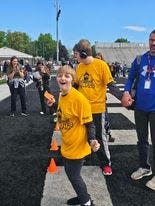 Aleria DiFrangia reacts after putting a football through the target at the 37th annual Exceptional Olympics.