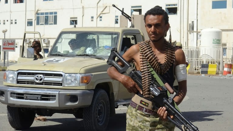 A Yemeni pro-government fighter stands in front of the May 22 Hospital on the eastern outskirts of Hodeida on November 15, 2018