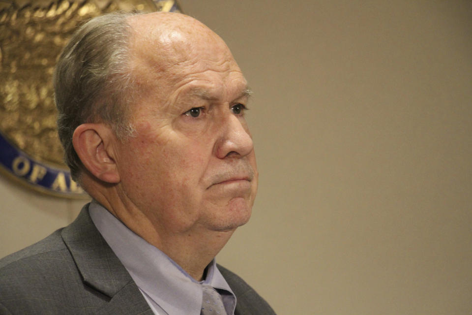 Alaska Gov. Bill Walker looks on while the state's new lieutenant governor, Valerie Davidson, addresses a news conference Tuesday, Oct. 16, 2018, in Anchorage, Alaska. Davidson was sworn in Tuesday after former Lt. Gov. Byron Mallott resigned after the governor's office said he made "inappropriate comments." (AP Photo/Mark Thiessen)