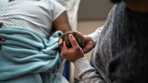 PHOTO: Son holding father's hand at the hospital (STOCK IMAGE/Getty Images)