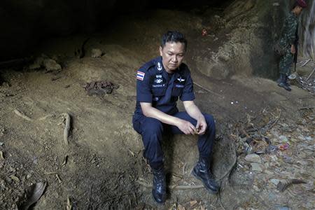 Police Major General Thatchai Pitaneelaboot rests during a trek through a forest to locate a trafficking camp in Satun, southern Thailand March 27, 2014. REUTERS/Andrew RC Marshall