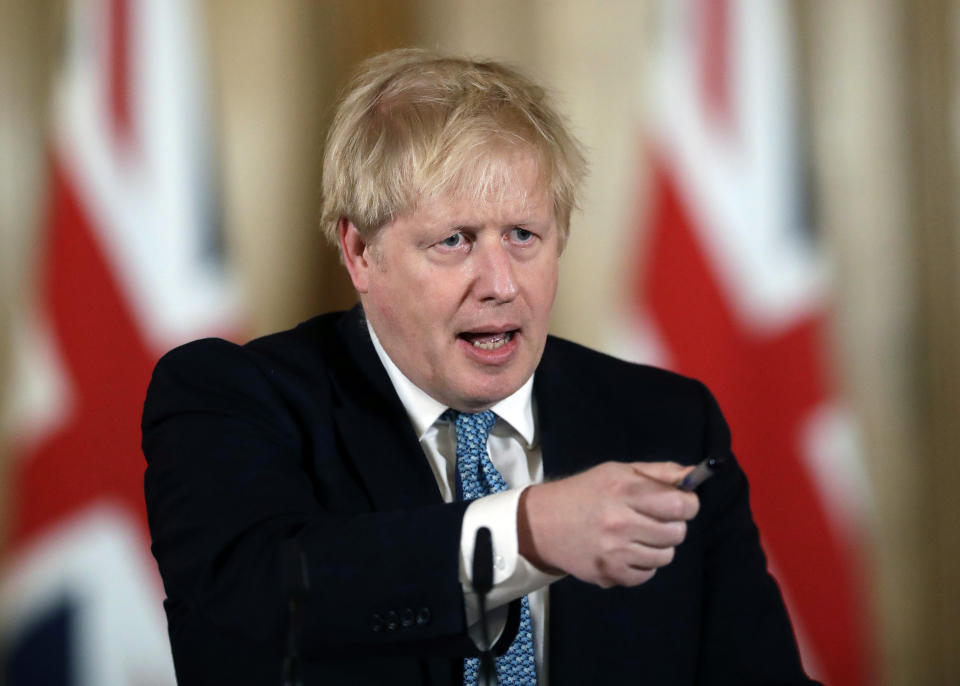 FILE - In this Tuesday, March 17, 2020 file photo, British Prime Minister Boris Johnson gestures as he gives a press conference about coronavirus inside 10 Downing Street in London. British Prime Minister Boris Johnson has been discharged from a London hospital where he was treated in intensive care for the new coronavirus. Johnson’s office says he left St. Thomas’ Hospital Sunday, April 12 and will continue his recovery at his country house Chequers. He will not immediately return to work. (AP Photo/Matt Dunham, file)