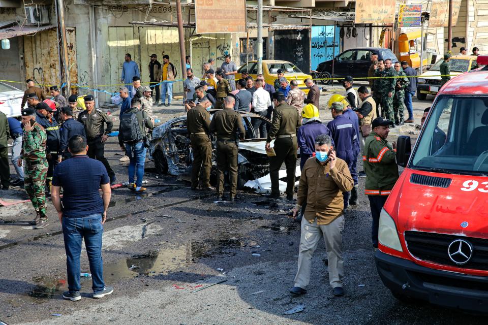 Iraqi security forces inspect the site of an explosion in Basra, Iraq, Tuesday, Dec. 7, 2021. The explosion rocked the center of Iraq’s southern city of Basra, killing at least four people and wounding several others. Local news reports initially reported a car bomb, but the governor of Basra told reporters on the scene that a motorcycle had exploded. (AP Photo/Nabil al-Jurani)