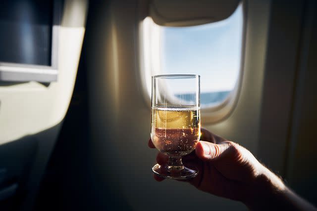 <p>Chalabala/Getty Images</p> It's tempting, but experts recommend skipping alcohol in-flight – or at least limiting your intake.