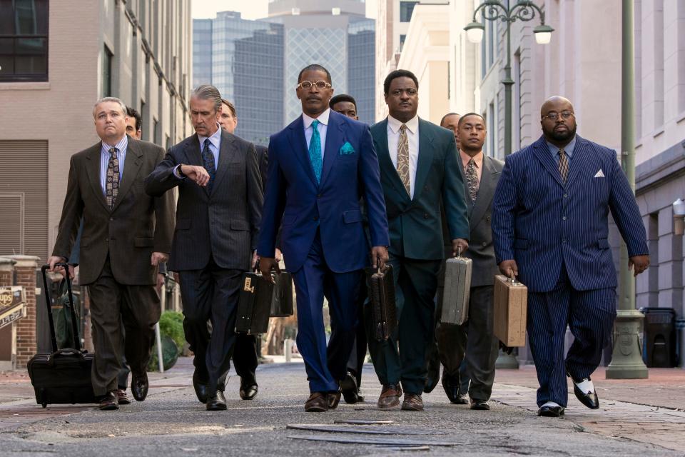 Jamie Foxx (center) stars as Willie Gary, a charismatic attorney hired to save a family funeral-home business in the comedic drama "The Burial."