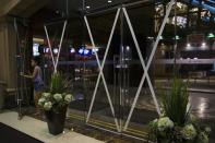 A girl walks into a shopping mall, which entrances are taped in anticipation of Typhoon Usagi, in Hong Kong September 21, 2013. Packing winds of 185 kph (114 mph) near the center and gusts of up to 220 kph, Typhoon Usagi on Saturday weakened after hitting the Batanes island group, and is moving slowly west-northwest at 19 kph towards southern China, the weather bureau said. REUTERS/Tyrone Siu (CHINA - Tags: ENVIRONMENT DISASTER BUSINESS)