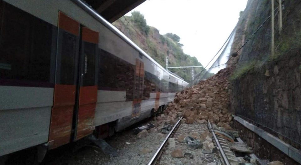 A landslide collides with a passenger train, near Vacarisses, some 45 kilometers northwest of Barcelona, Spain, Tuesday Nov. 20, 2018. One person died and dozens were injured Tuesday after a landslide derailed a commuter train traveling toward Barcelona, Spanish authorities said. (Anti-radar Catalunya via AP)