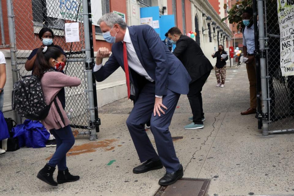 New York City Mayor Bill de Blasio elbow bumps a student at P.S. 188 as he welcomes elementary school students back to the city’s public schools for in-person learning on September 29, 2020 in New York City. (Photo by Spencer Platt/Getty Images)