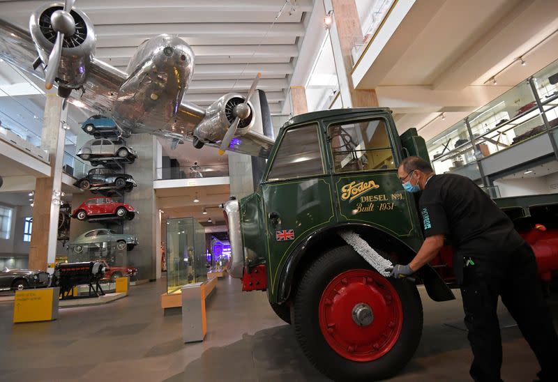 Employees clean exhibits ahead of the reopening of the Science Museum, in London, Britain