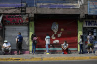 People wait in a socially distanced line to enter a bank, in Ecatepec, a Mexico City suburb, Wednesday, May 20, 2020. Mexico City, one of the world's largest cities and the epicenter of the country's coronavirus epidemic, will begin a gradual reopening June 1, its mayor said Wednesday, even as daily new infections continued to set records. (AP Photo/Rebecca Blackwell)