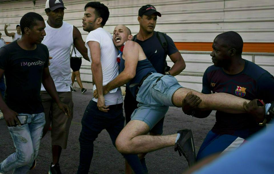 FILE - In this May 11, 2019 file photo, police detain a gay rights activist taking part in an unauthorized march in Havana, Cuba. The march was organized using Cuba's new mobile internet, with activists and supporters calling for a rally over Facebook and WhatsApp after the government-run gay rights organization cancelled a march. (AP Photo/Ramon Espinosa, File)