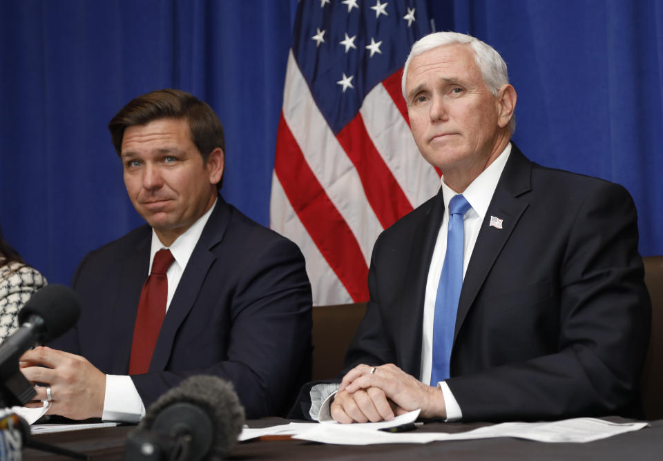 Vice President Mike Pence, right, and Florida Gov. Ron DeSantis take questions during a Florida Coronavirus Response Meeting, at the West Palm Beach International Airport, Friday, Feb. 28, 2020, in West Palm Beach, Fla. (AP Photo/Terry Renna)