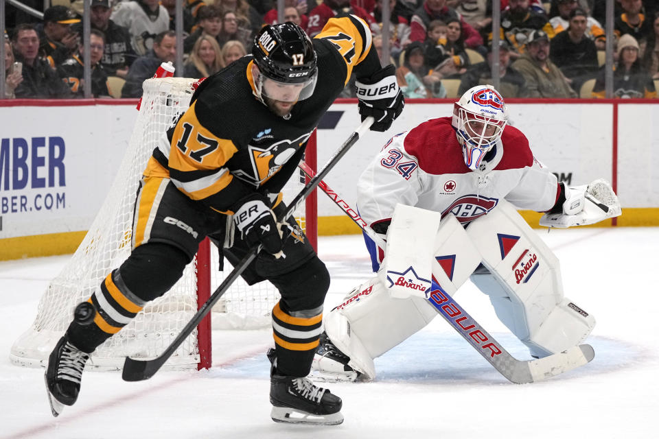 Pittsburgh Penguins' Bryan Rust (17) cannot get his stick on a pass in front of Montreal Canadiens goaltender Jake Allen (34) during the second period of an NHL hockey game in Pittsburgh, Saturday, Jan. 27, 2024. (AP Photo/Gene J. Puskar)