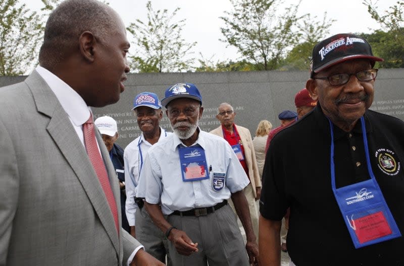 In this Aug. 3, 2011, file photo, Harry E. Johnson Sr., left, president & CEO of the Martin Luther King Jr. Foundation, takes Tuskegee Airmen, including Theodore Lumpkin Jr., center, and Dabney Montgomery, right, on a tour of the Martin Luther King Jr. Memorial in Washington. (AP Photo/Jacquelyn Martin, File)