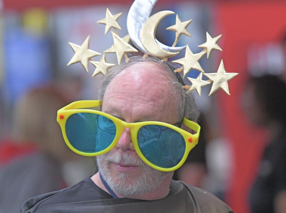 David Weigold wears an eclipse-themed costume Thursday morning while volunteering in the Emergency Management Association booth at the 17th annual Richland Area Chamber & Economic Development Expo.