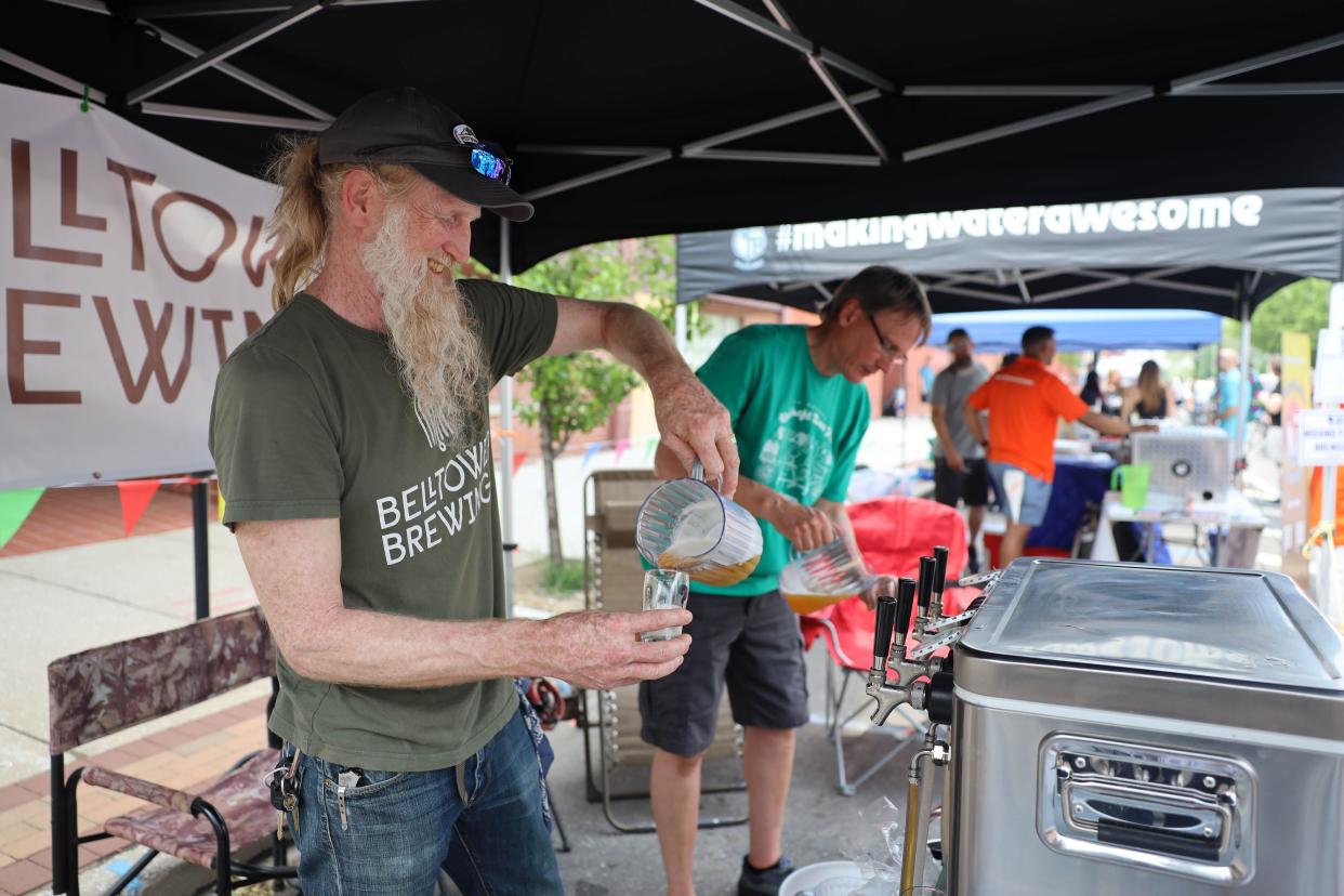 Bell Tower Brewing Co.'s Karl Walter pours samples at the Kent Jaycee’s Craft Beer Fest in downtown Kent last year.