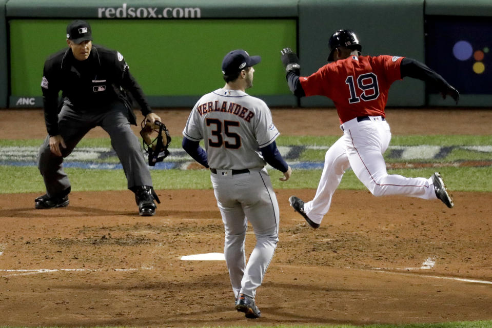 Boston Red Sox's Jackie Bradley Jr., right, scores past Houston Astros starting pitcher Justin Verlander on a wild pitch during the fifth inning in Game 1 of a baseball American League Championship Series on Saturday, Oct. 13, 2018, in Boston. (AP Photo/Elise Amendola)