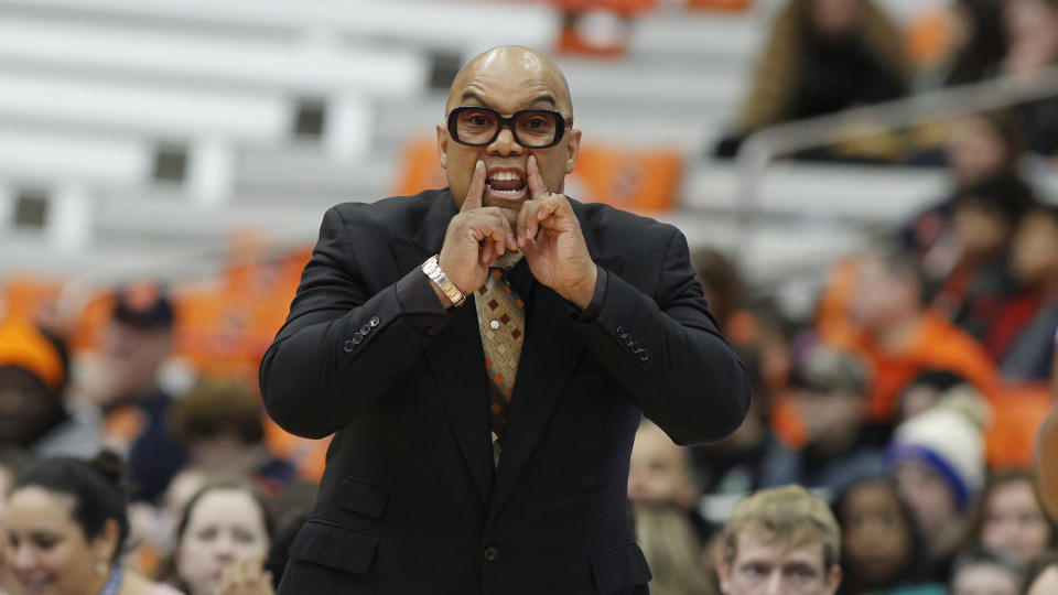 FILE - Syracuse head coach Quentin Hillsman yells to his players in the first quarter of an NCAA college basketball game against Louisville in Syracuse, N.Y., in this Sunday, Feb. 9, 2020, file photo. Syracuse coach Quentin Hillsman has had 11 players enter the NCAA transfer portal and has brought in four players to help make up for the losses. He says the Orange are in a good place and “not in panic mode.” Among those who have departed are leading scorer Kiara Lewis and Emily Engstler, who led the team in rebounding as the first player off the bench. (AP Photo/Nick Lisi, File)