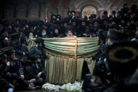 <p>Ultra-Orthodox Jews gather for the traditional Jewish wedding for Chananya Yom Tov Lipa, the great-grandson of the rabbi of the Wiznitz Hasidic followers, in the Israeli town of Petah Tikva near Tel Aviv, Israel, on Feb. 14, 2012. (Photo: Oded Balilty/AP) </p>