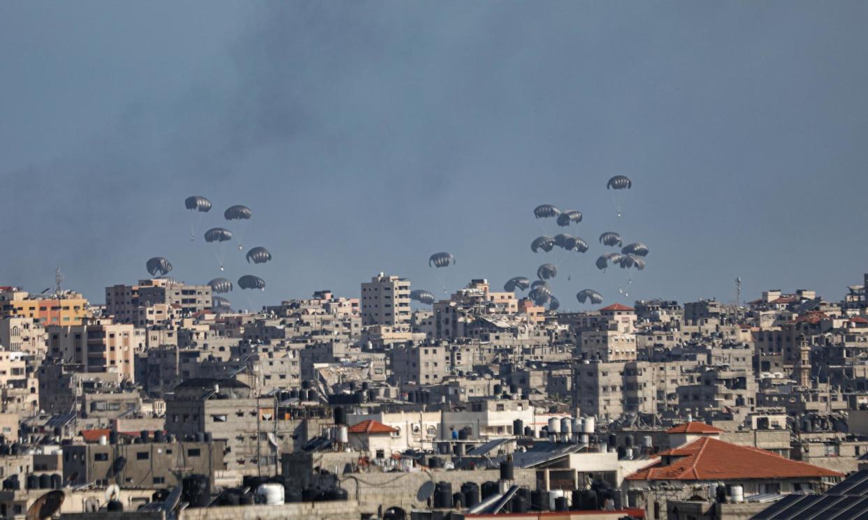 <span>Humanitarian aid packages are dropped from a plane on 11 April as Israeli attacks continue.</span><span>Photograph: Dawoud Abo Alkas/Anadolu/Getty Images</span>