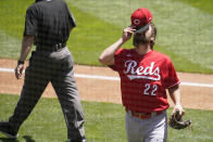 Cincinnati Reds pitcher Wade Miley puts his cap back on following an inspection for any illegal substance by umpires after the third inning of a baseball game against the Minnesota Twins, Tuesday, June 22, 2021, in Minneapolis. (AP Photo/Jim Mone)