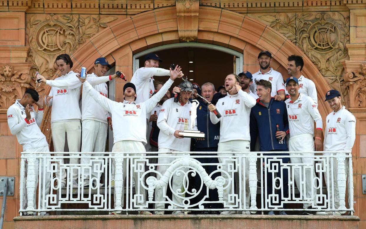 Essex captain Tom Westley holds the Bob Willis Trophy as he celebrates on the Pavilion balcony with his teammates and head coach Anthony McGrath during Day 5 of the Bob Willis Trophy Final between Somerset and Essex at Lord's Cricket Ground on September 27, 2020 in London, England.  - GETTY IMAGES