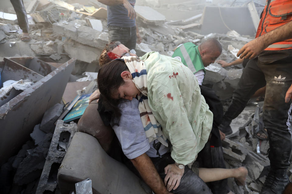 An injured Palestinian man hugs an injured relative after being rescued following Israeli airstrikes on Gaza City, Wednesday, Oct. 25, 2023. (AP Photo/Abed Khaled)