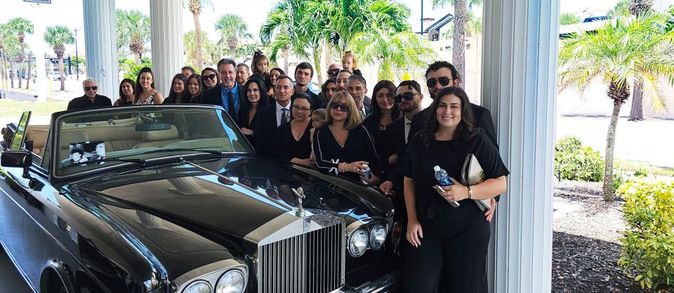 Frank Cassata’s family members pose with his Rolls-Royce convertible at Toale Brothers Funeral Home in Sarasota. As a tribute to their father, Cassata’s children rode the the funeral home in the vehicle.