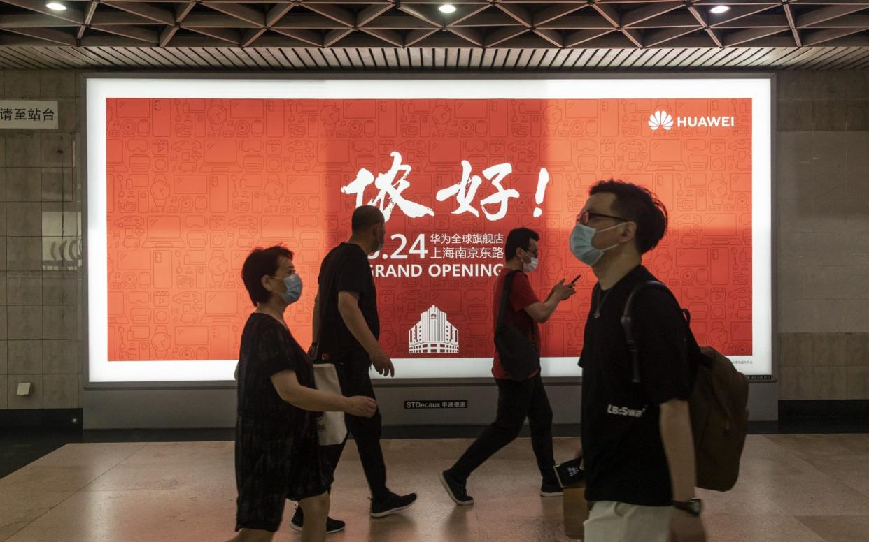 An advert for Huawei's new flagship store in Shanghai. The US claims the company has close connections to the Chinese military - BLOOMBERG