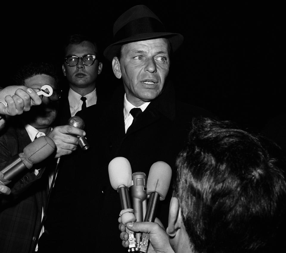 Actor Frank Sinatra, Sr., tells newsmen outside the Hollywood home of his divorced wife, Nancy, that his son, Frank, Jr., is safely inside the house in Los Angeles, December 11, 1963. Sinatra said $24O,OOO in ransom had been paid for the boy's return. (AP Photo/Harold P. Matosian)