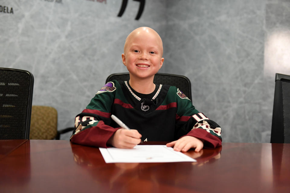 GLENDALE, ARIZONA - NOVEMBER 16: Eight-year old Leighton Accardo, who is battling germ cell cancer, signs a contract with the Arizona Coyotes to become a player for a day as part of Hockey Fights Cancer prior to a game between the Coyotes and Calgary Flames at Gila River Arena on November 16, 2019 in Glendale, Arizona. (Photo by Norm Hall/NHLI via Getty Images)