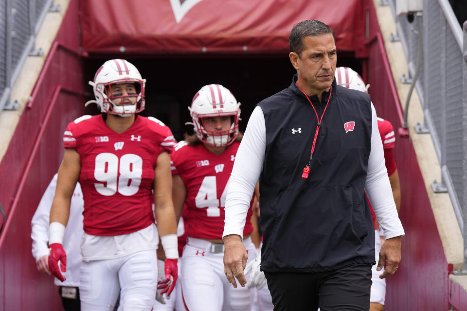Oct .14, 2023; Madison, Wisconsin; Wisconsin Badgers head coach Luke Fickell leads the football team onto the field for warmups prior to the game against the Iowa Hawkeyes at Camp Randall Stadium. Jeff Hanisch-USA TODAY Sports