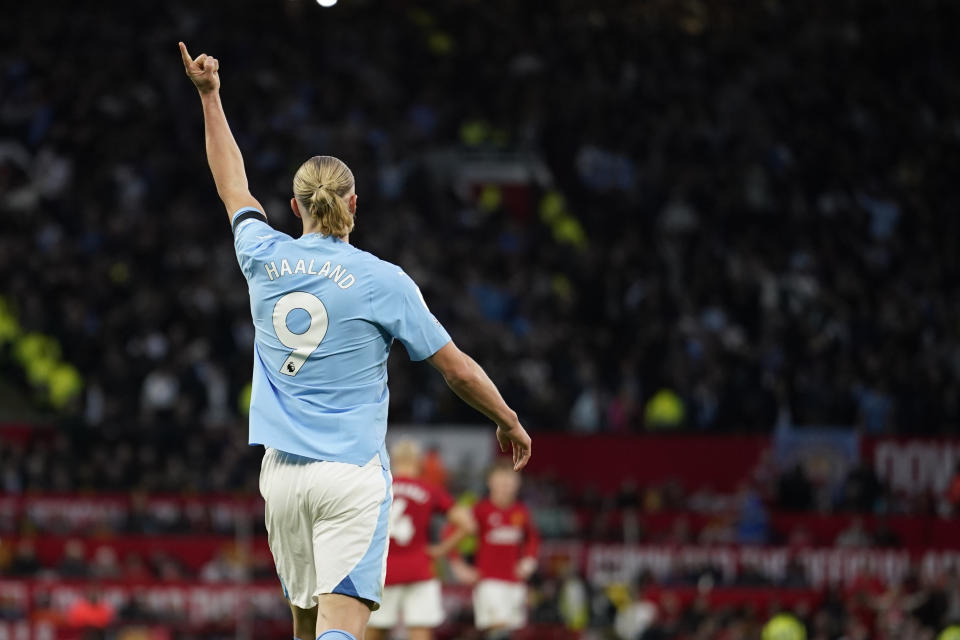 Manchester City's Erling Haaland celebrates after scoring his side's opening goal from a penalty kick during the English Premier League soccer match between Manchester United and Manchester City at Old Trafford stadium in Manchester, England, Sunday, Oct. 29, 2023. (AP Photo/Dave Thompson)