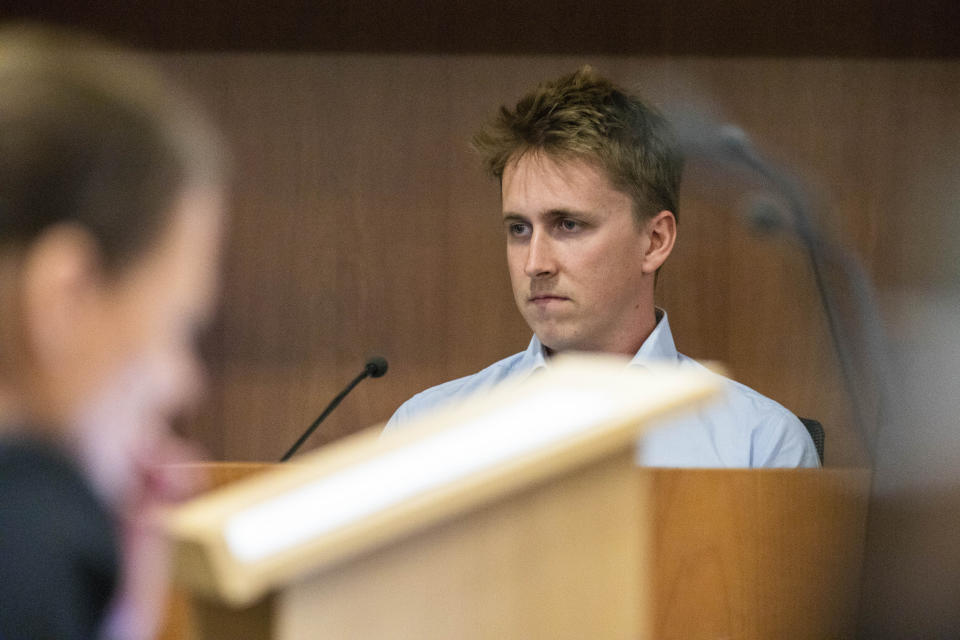 Pilot Brian Depauw reacts in the witness box at the Whakaari White Island eruption trial at the Auckland Environment Court, in Auckland, New Zealand, Thursday July 13, 2023. Depauw, a helicopter pilot said Thursday he and two of his passengers had escaped serious injury by jumping into the ocean when a New Zealand volcano erupted in 2019, killing 22. (Nick Monro/Pool Photo via AP)