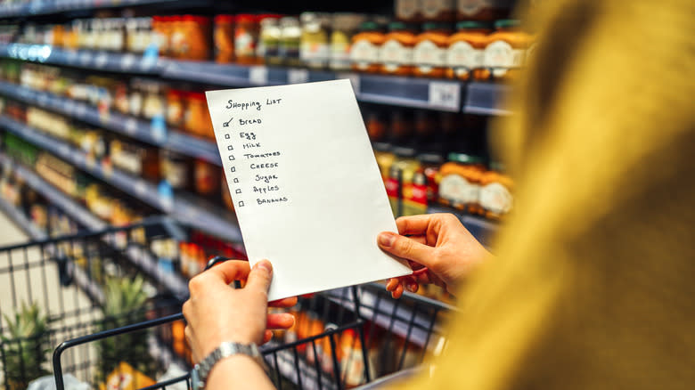 Person hold shopping list in store