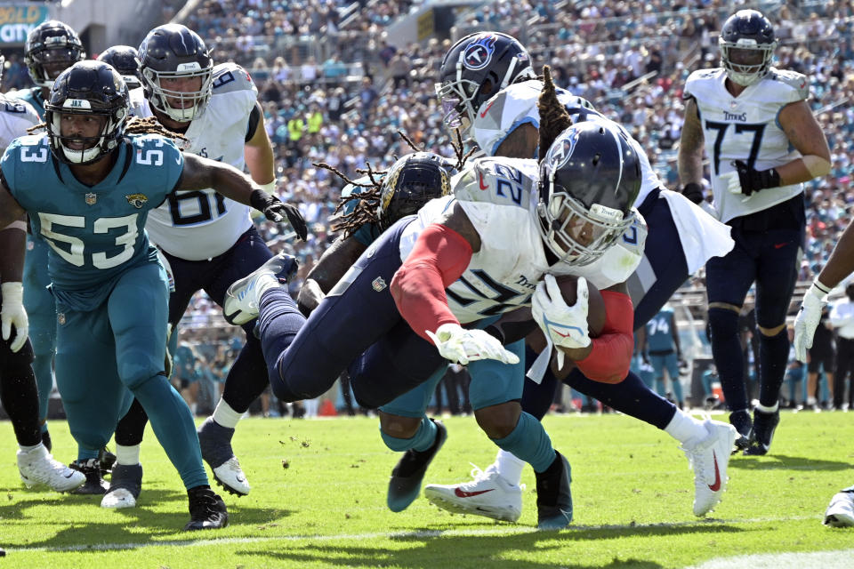 Tennessee Titans running back Derrick Henry (22) dives for a touchdown past Jacksonville Jaguars linebacker Dakota Allen (53) during the second half of an NFL football game, Sunday, Oct. 10, 2021, in Jacksonville, Fla. (AP Photo/Phelan M. Ebenhack)