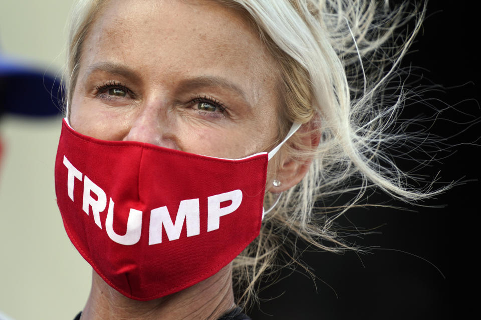 A supporter watches as President Donald Trump speaks during a campaign rally at Wittman Airport, Monday, Aug. 17, 2020, in Oshkosh, Wis. (AP Photo/Evan Vucci)