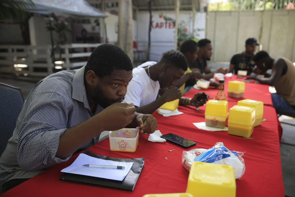 Clients eat soup joumou at a restaurant in the Delmas district of Port-au-Prince, Haiti, Sunday, Feb. 5, 2023. Soup joumou, also known as “independence soup,” is traditionally eaten on Sunday mornings, and on Haitian Independence Day in early January. (AP Photo/Odelyn Joseph)