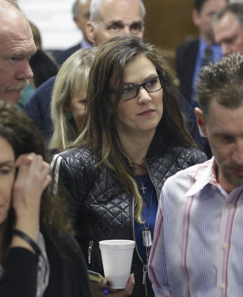 Taya Kyle, wife of former Navy SEAL Chris Kyle, leaves the courtroom after a break in the capital murder trial of Eddie Ray Routh at the Erath County, Donald R. Jones Justice Center Friday, Feb. 20, 2015, in Stephenville, Texas.  Routh, 27, of Lancaster, is charged with the 2013 deaths of  Kyle and his friend Chad Littlefield at a shooting range near Glen Rose, Texas. (AP Photo/LM Otero,Pool)