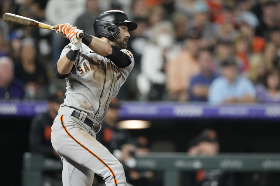 FILE - San Francisco Giants' Steven Duggar follows the flight of his RBI-single off Colorado Rockies relief pitcher Jordan Sheffield in the eighth inning of a baseball game Saturday, Sept. 25, 2021, in Denver. The Giants acquired Willie Calhoun on Thursday, June 23, 2022, sending outfielder Steven Duggar to Texas. (AP Photo/David Zalubowski, File)