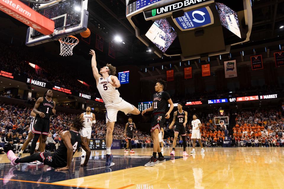 Virginia's Ben Vander Plas (5) shoots the ball against Louisville during the second half of an NCAA college basketball game in Charlottesville, Va., Saturday, March 4, 2023. (AP Photo/Mike Kropf)