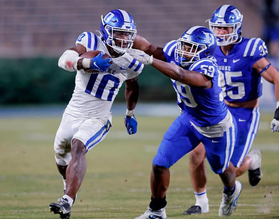Peyton Jones runs the ball under pressure from Michael Reese during Duke’s spring football game on Friday, April 21, 2023, at Wallace Wade Stadium in Durham, N.C.