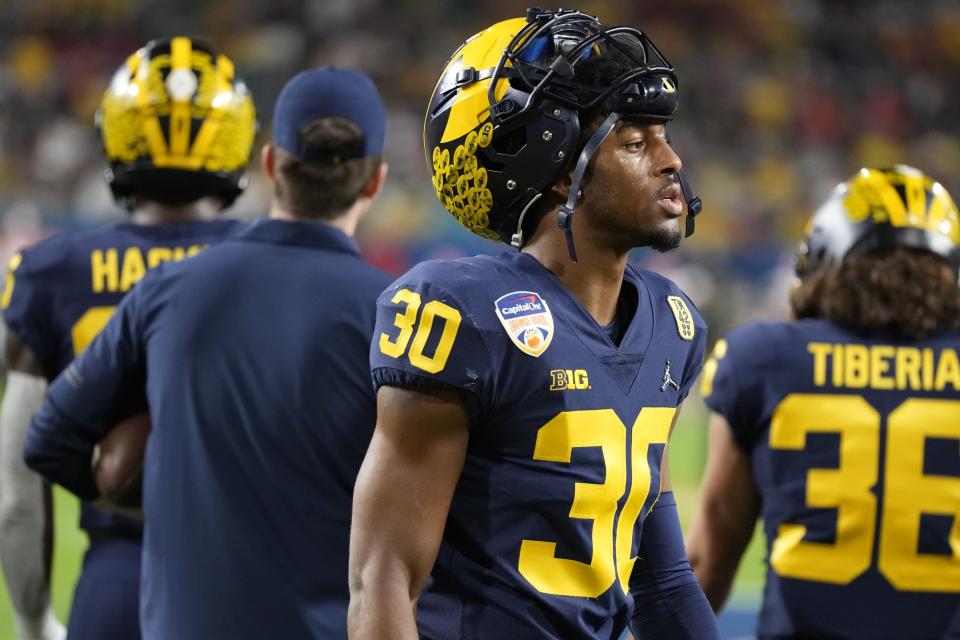 Michigan defensive back Daxton Hill walks the turf before the first half of the Orange Bowl NCAA College Football Playoff semifinal game against Georgia, Friday, Dec. 31, 2021, in Miami Gardens, Fla. (AP Photo/Rebecca Blackwell)