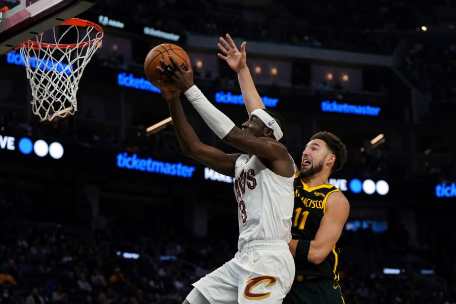 Cleveland Cavaliers guard Caris LeVert (3) drives to the basket as Golden State Warriors guard Klay Thompson (11) defends during the first half of an NBA basketball game Saturday, Nov. 11, 2023, in San Francisco. (AP Photo/Loren Elliott)