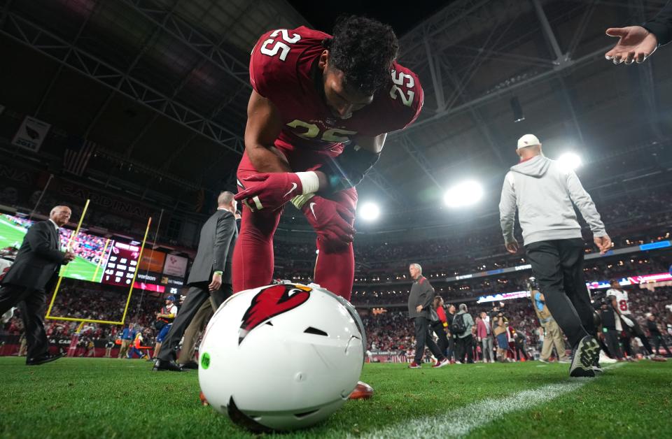 Dec 25, 2022; Glendale, Arizona, USA; Arizona Cardinals linebacker Zaven Collins (25) doubles over after losing in overtime 19-16 against the Tampa Bay Buccaneers at State Farm Stadium.