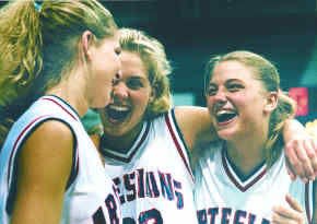 Martinsville High School seniors, from left, Leslie Deaton, Kristen Bodine and April Traylor, celebrate their Tournament of Champions victory at Hinkle Fieldhouse in Indianapolis Saturday. The Artesians defeated Southridge,74-61. Staff Photo by Mark Hume.