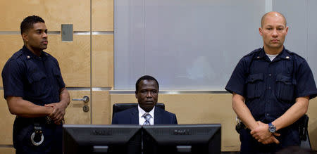 Dominic Ongwen, a Ugandan commander in the Lord's Resistance Army, waits for the start of court procedures as he makes his first appearance at the International Criminal Court in The Hague January 26, 2015. REUTERS/Peter Dejong/Pool/File Photo