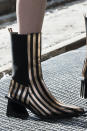 <p><i>Gold-and-black-striped chelsea boots from the SS18 Marques’Almeida collection. (Photo: ImaxTree) </i></p>