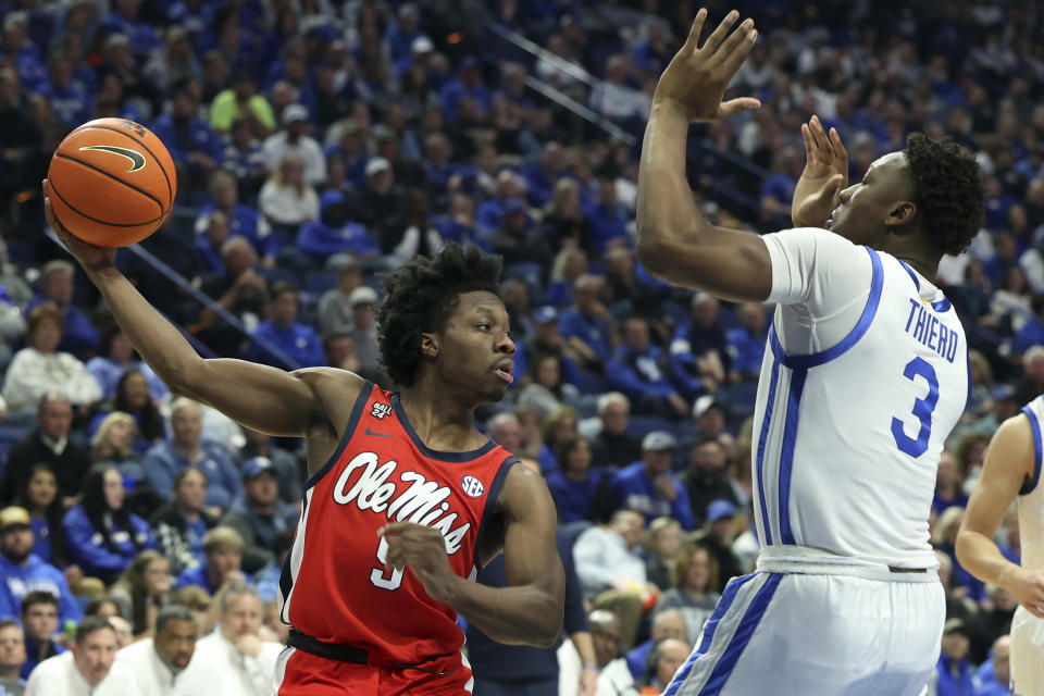 Mississippi's Jaylen Murray, left, passes the ball around Kentucky's Adou Thiero (3) during the first half of an NCAA college basketball game Tuesday, Feb. 13, 2024, in Lexington, Ky. Kentucky won 75-63. (AP Photo/James Crisp)