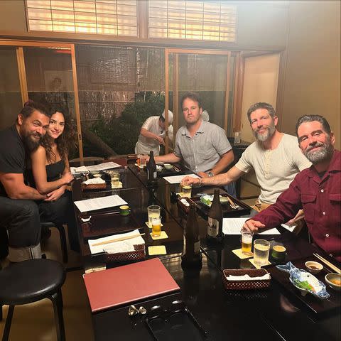 <p>Instagram/prideofgypsies</p> Jason Momoa and Adria Arjona cuddle during a dinner